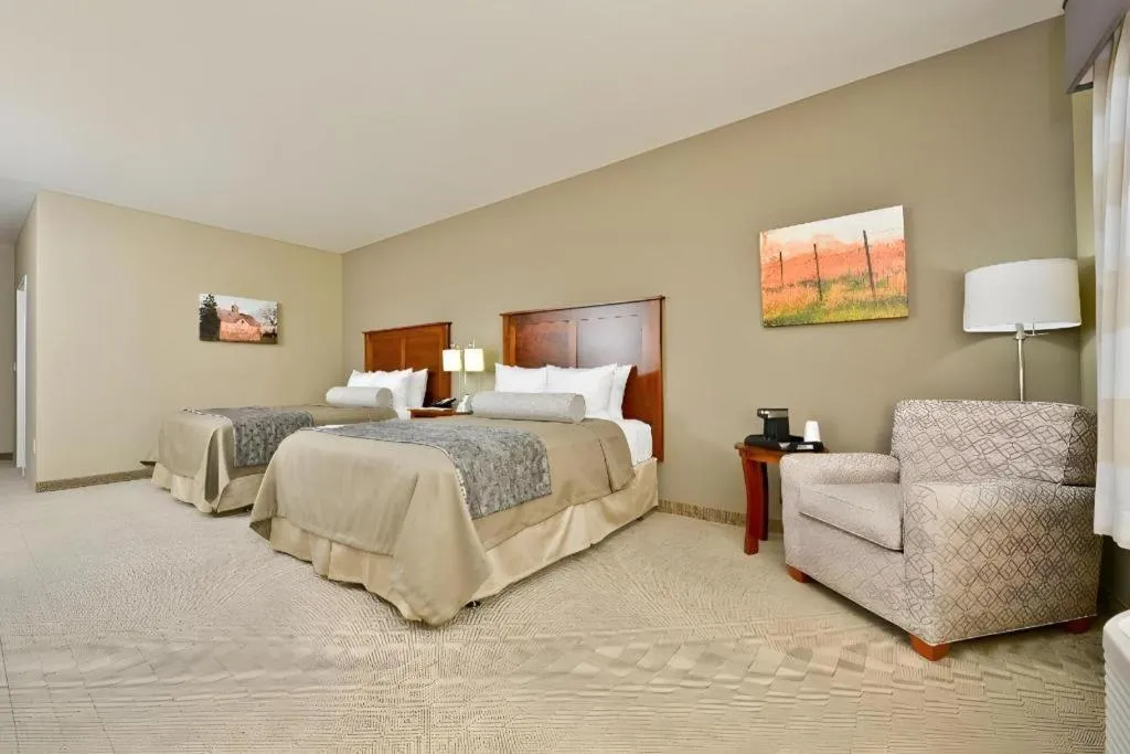 Bed in Green Mill Village Hotel & Suites, BW Signature Collection