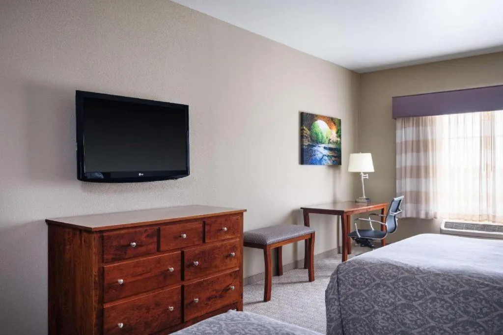 Bed in Green Mill Village Hotel & Suites, BW Signature Collection