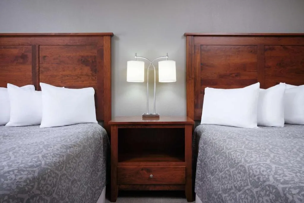 Bed in Green Mill Village Hotel & Suites, BW Signature Collection