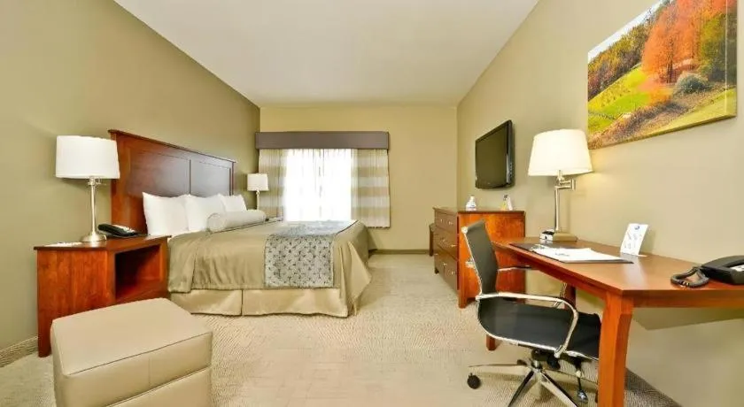 Bed in Green Mill Village Hotel & Suites, BW Signature Collection
