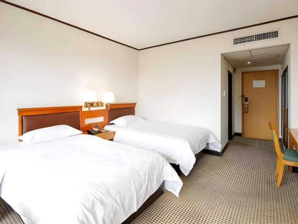 Bed in Nanfang Dasha Hotel