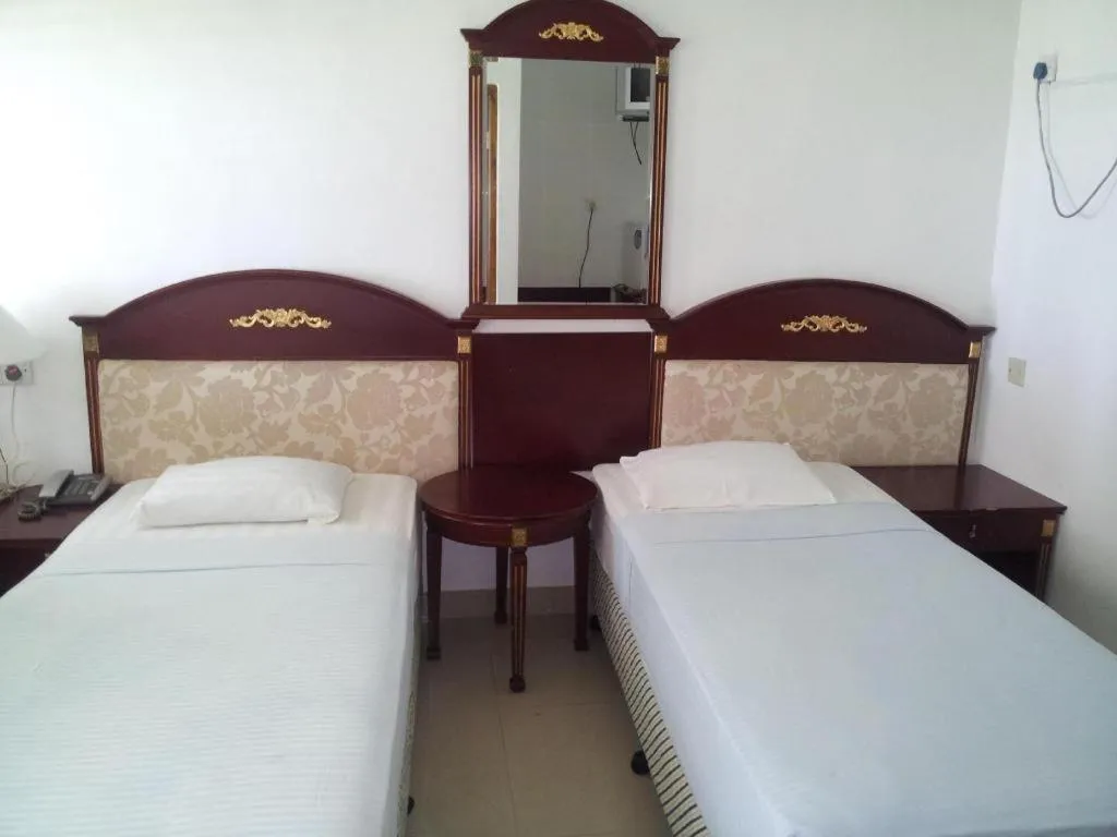 Bed in New Tristar Beach Hotel