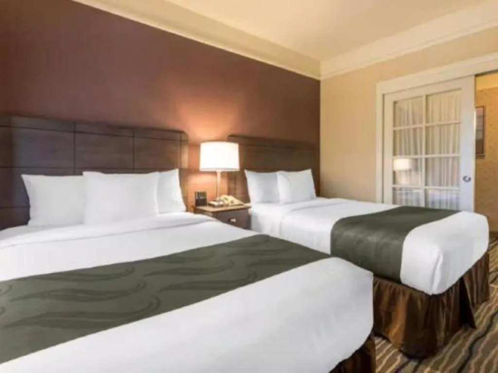 Bed in Ramada Suites by Wyndham San Diego