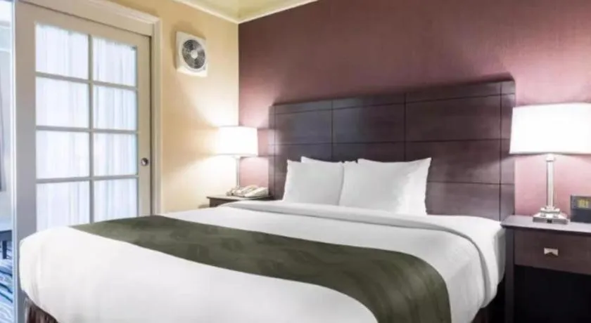 Bed in Ramada Suites by Wyndham San Diego