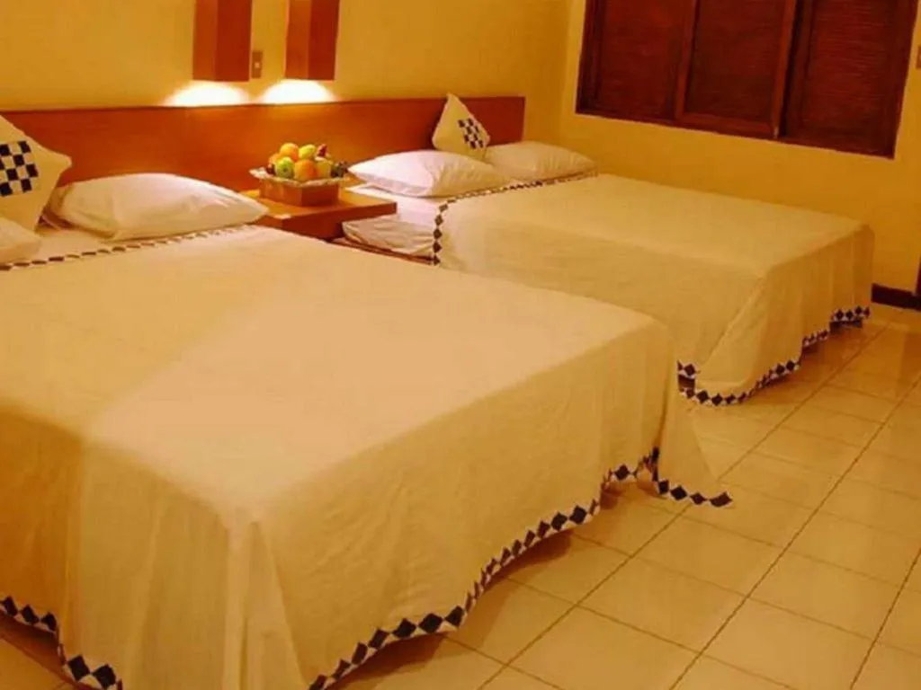 Bed in Nyiur Resort Hotel