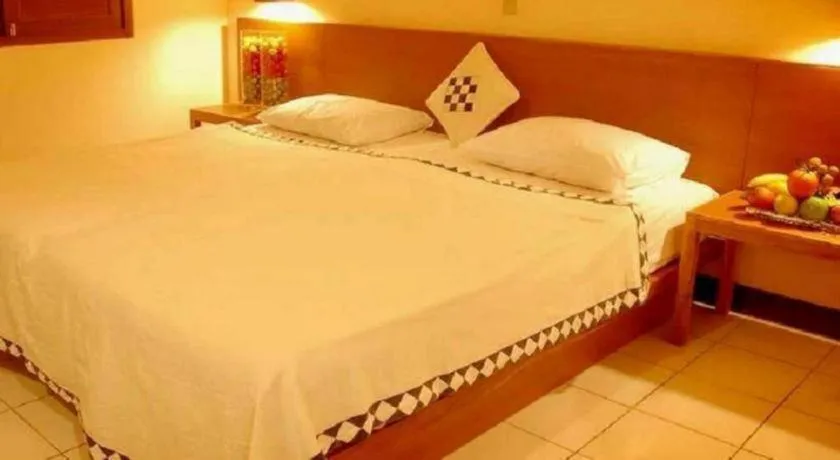Bed in Nyiur Resort Hotel