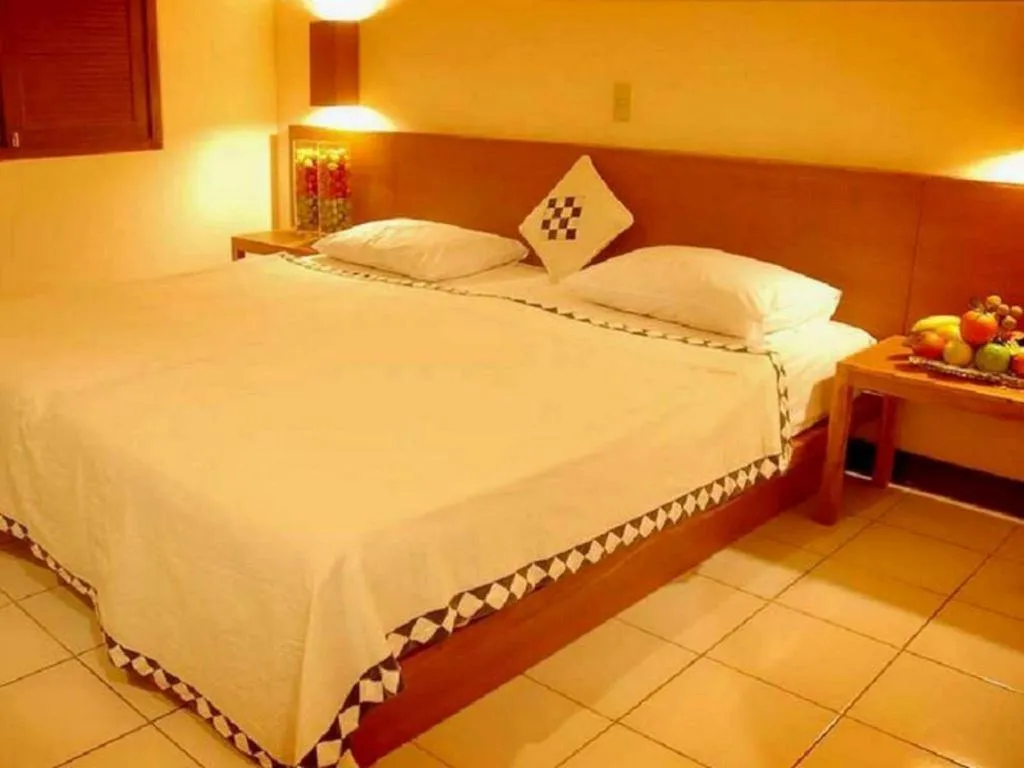 Bed in Nyiur Resort Hotel