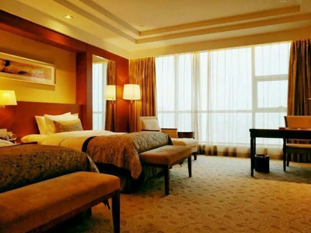 Bed in New Century Grand Hotel Ninghai Jinhai