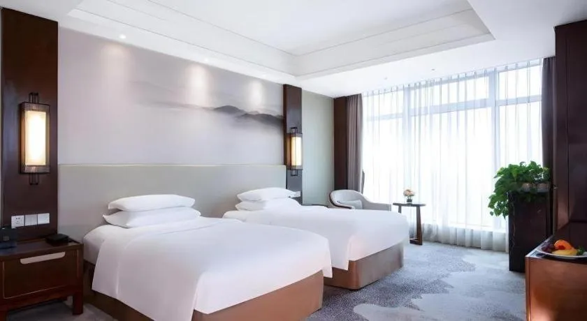 Bed in New Century Grand Hotel Hangzhou Fuyang Dongfangmao