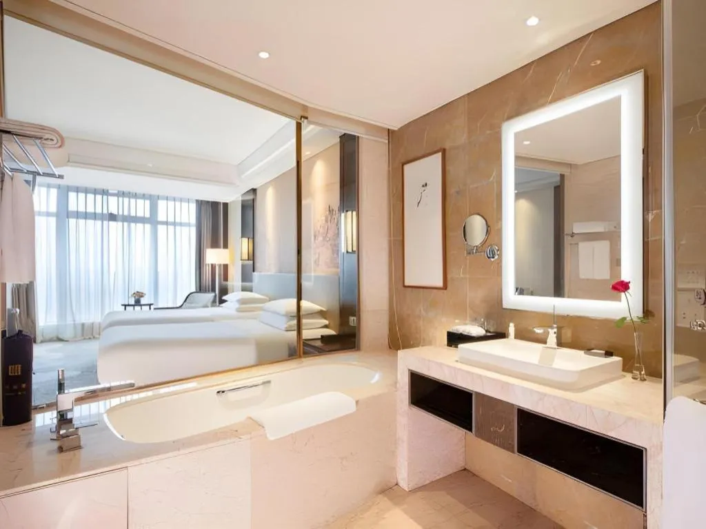 Bed in New Century Grand Hotel Hangzhou Fuyang Dongfangmao