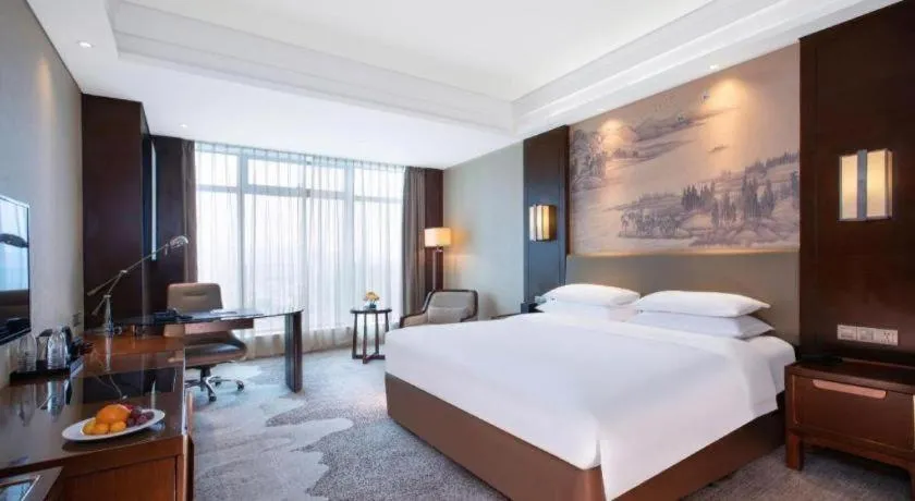 Bed in New Century Grand Hotel Hangzhou Fuyang Dongfangmao