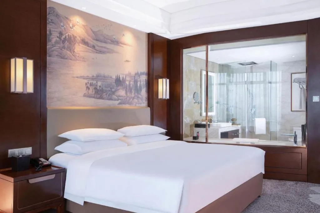 Bed in New Century Grand Hotel Hangzhou Fuyang Dongfangmao