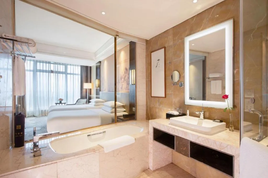 Bed in New Century Grand Hotel Hangzhou Fuyang Dongfangmao