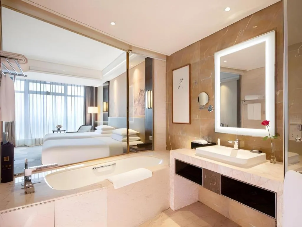 Bed in New Century Grand Hotel Hangzhou Fuyang Dongfangmao