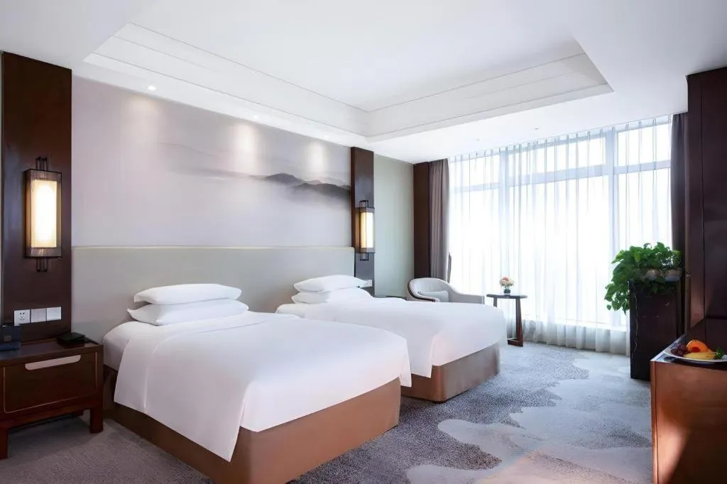 Bed in New Century Grand Hotel Hangzhou Fuyang Dongfangmao