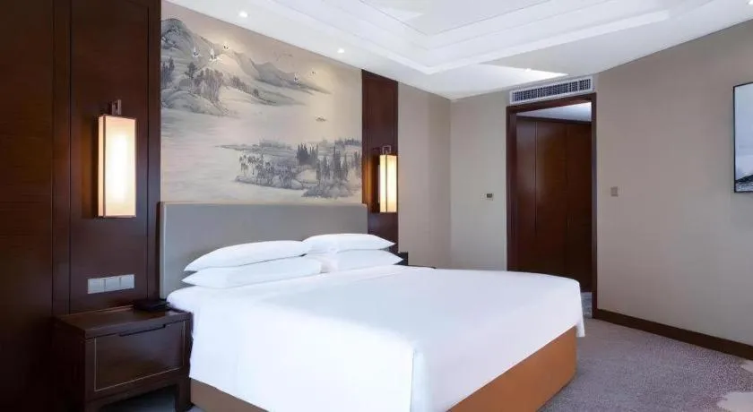 Bed in New Century Grand Hotel Hangzhou Fuyang Dongfangmao