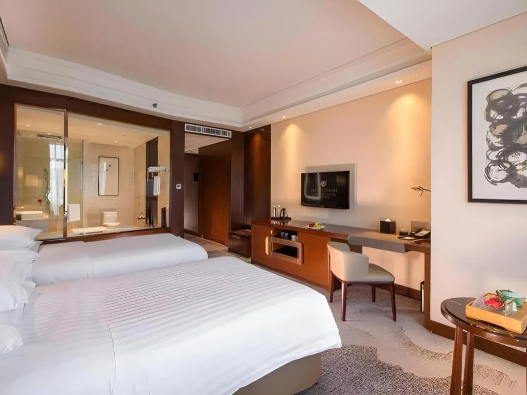 Bed in New Century Grand Hotel Hangzhou Fuyang Dongfangmao