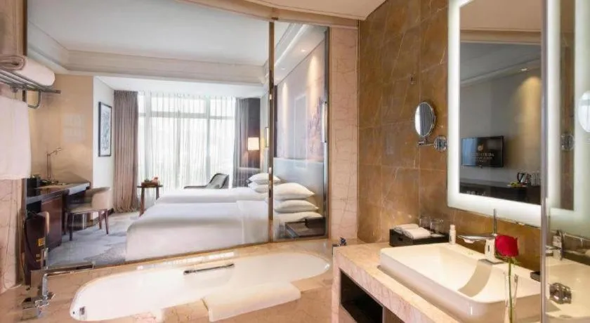 Bed in New Century Grand Hotel Hangzhou Fuyang Dongfangmao