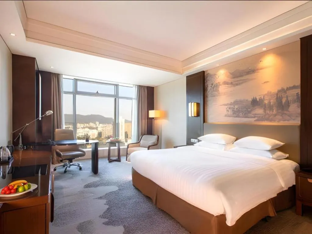 Bed in New Century Grand Hotel Hangzhou Fuyang Dongfangmao