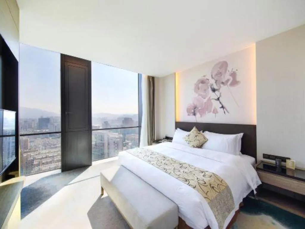 Bed in LONGYAN JINGHUA FLIPORT HOTEL