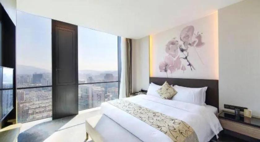 Bed in LONGYAN JINGHUA FLIPORT HOTEL