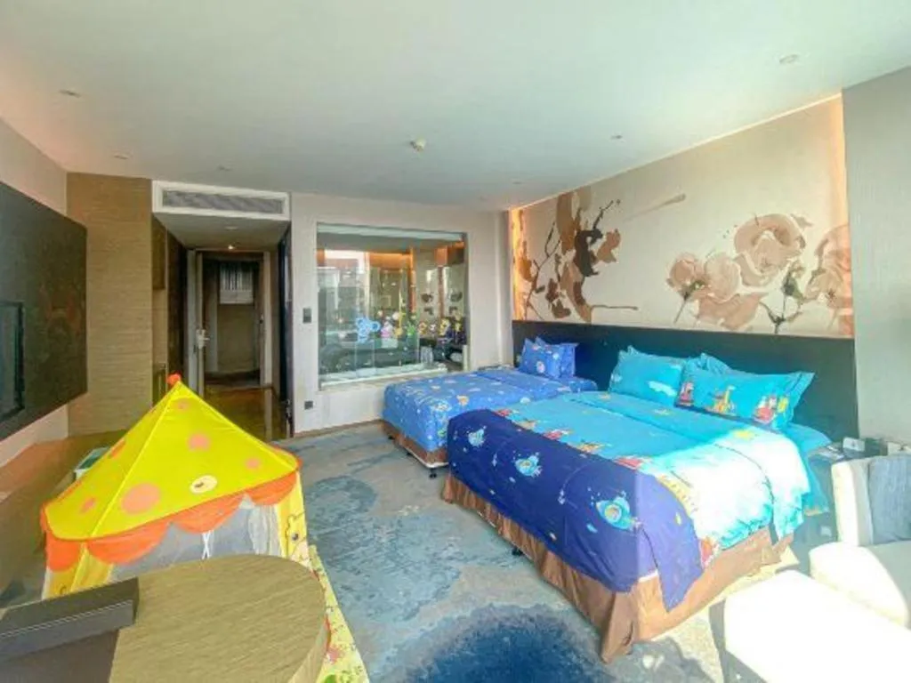 Bed in LONGYAN JINGHUA FLIPORT HOTEL