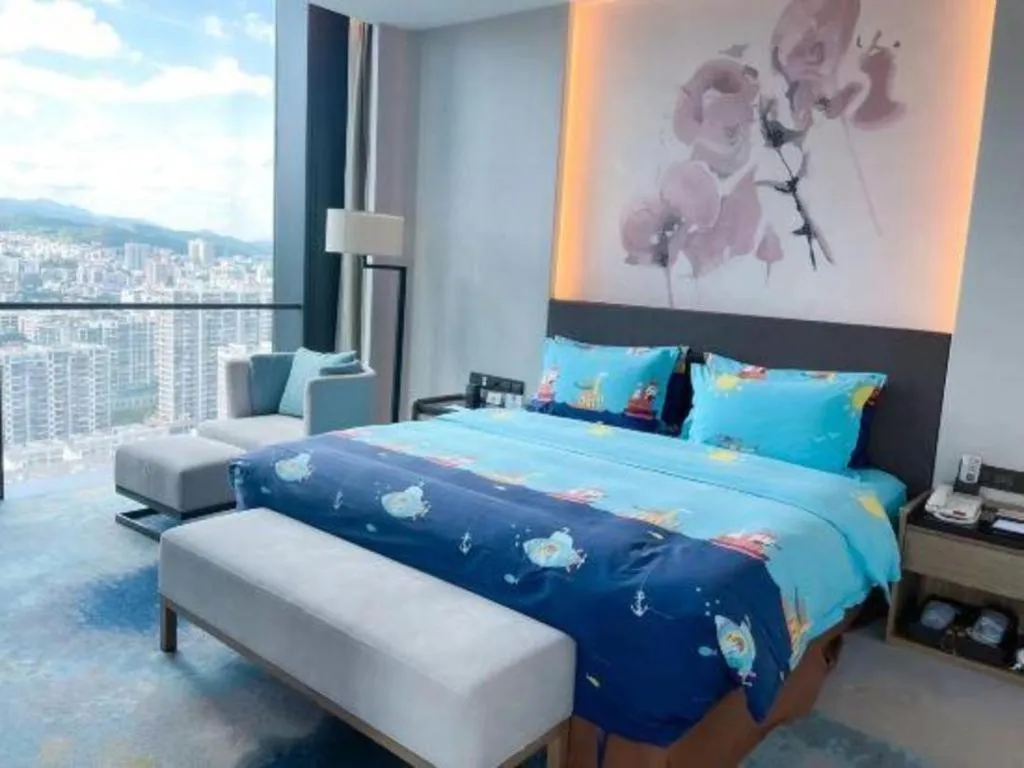 Bed in LONGYAN JINGHUA FLIPORT HOTEL