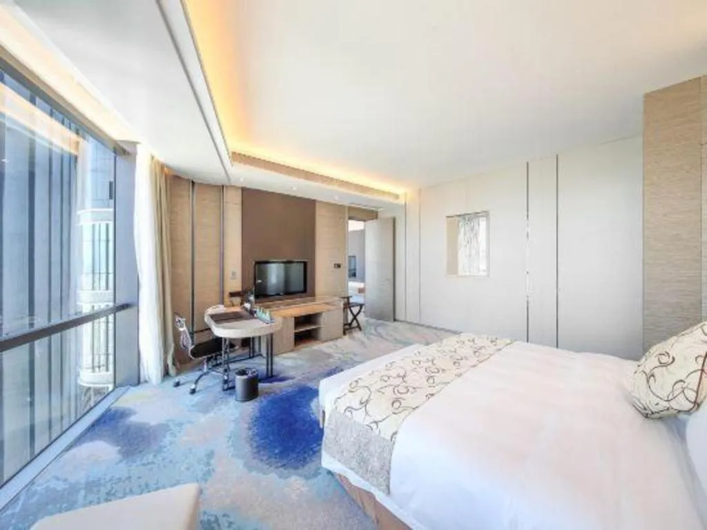 Bed in LONGYAN JINGHUA FLIPORT HOTEL