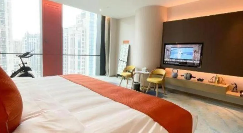 Bed in LONGYAN JINGHUA FLIPORT HOTEL