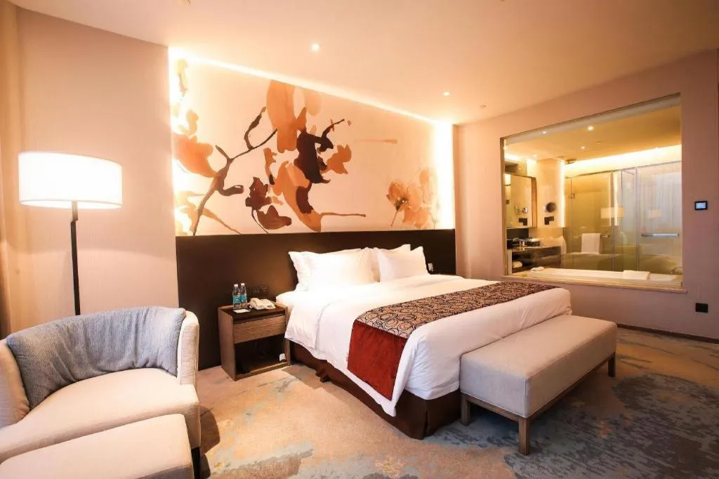 Bed in LONGYAN JINGHUA FLIPORT HOTEL