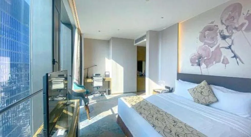 Bed in LONGYAN JINGHUA FLIPORT HOTEL