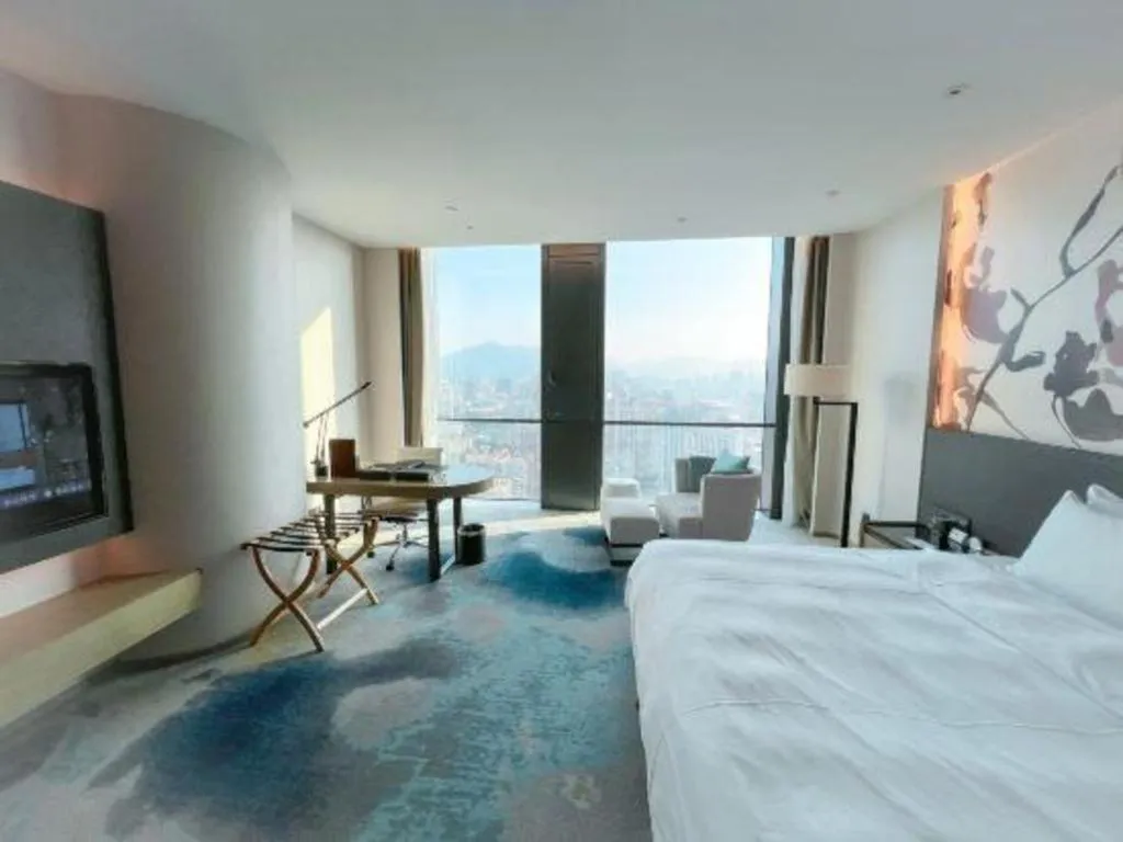 Bed in LONGYAN JINGHUA FLIPORT HOTEL