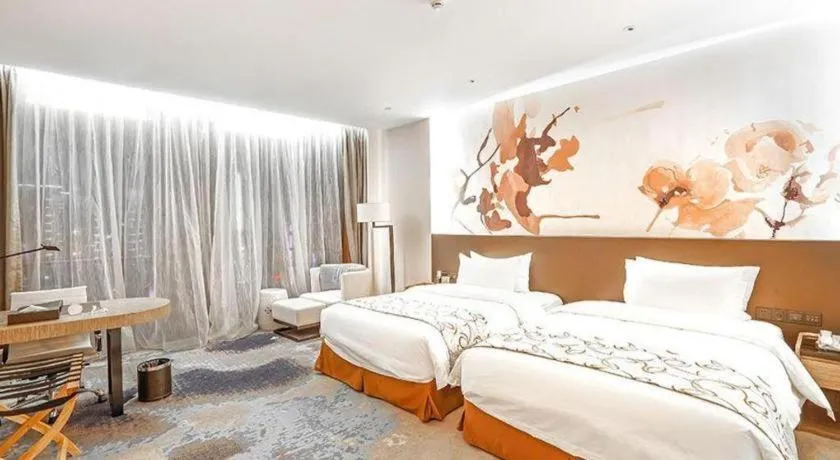 Bed in LONGYAN JINGHUA FLIPORT HOTEL