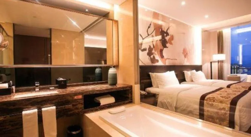 Bed in LONGYAN JINGHUA FLIPORT HOTEL