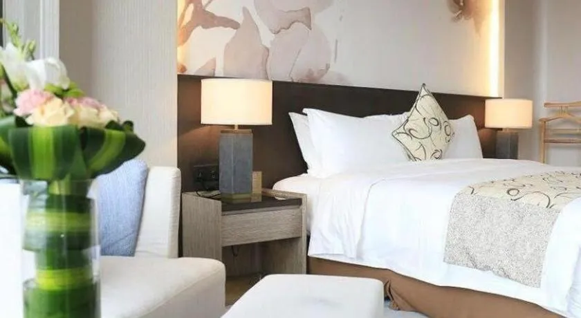 Bed in LONGYAN JINGHUA FLIPORT HOTEL