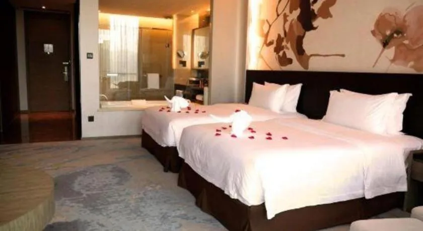 Bed in LONGYAN JINGHUA FLIPORT HOTEL