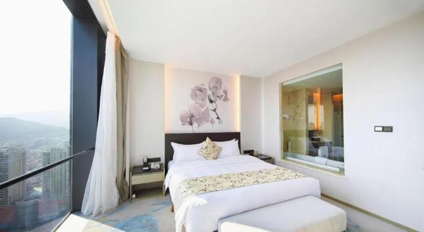 Bed in LONGYAN JINGHUA FLIPORT HOTEL