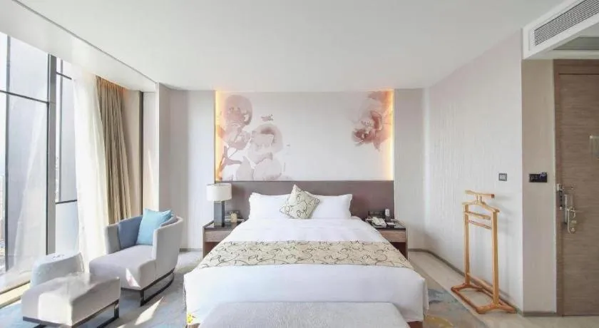 Bed in LONGYAN JINGHUA FLIPORT HOTEL