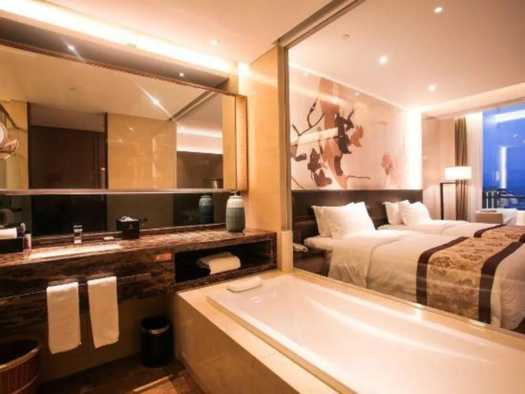 Bed in LONGYAN JINGHUA FLIPORT HOTEL