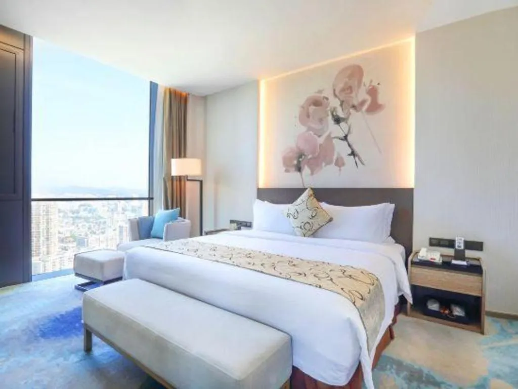 Bed in LONGYAN JINGHUA FLIPORT HOTEL