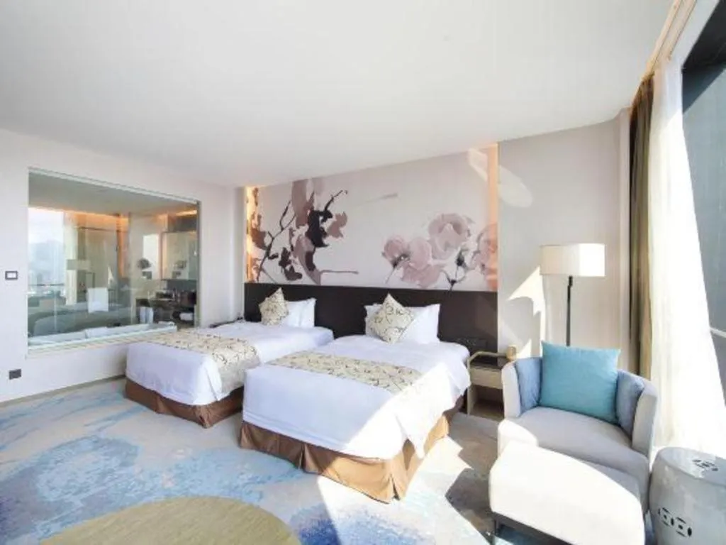 Bed in LONGYAN JINGHUA FLIPORT HOTEL