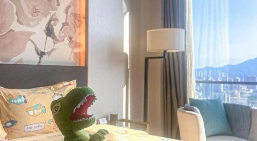 Bed in LONGYAN JINGHUA FLIPORT HOTEL