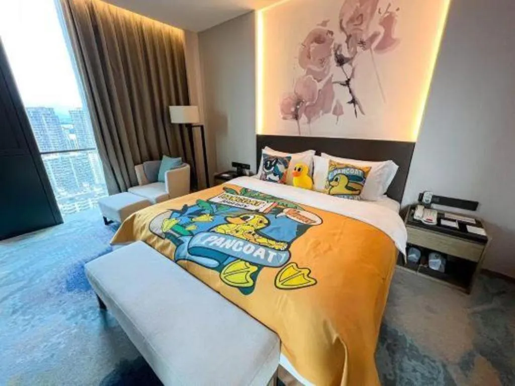 Bed in LONGYAN JINGHUA FLIPORT HOTEL