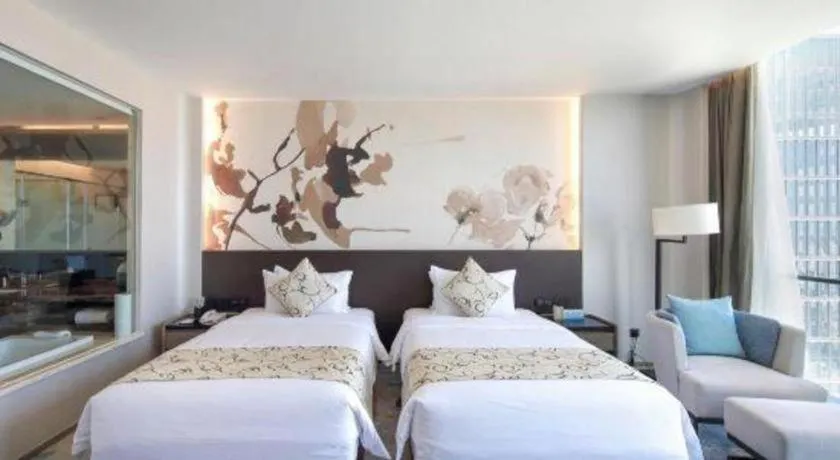 Bed in LONGYAN JINGHUA FLIPORT HOTEL