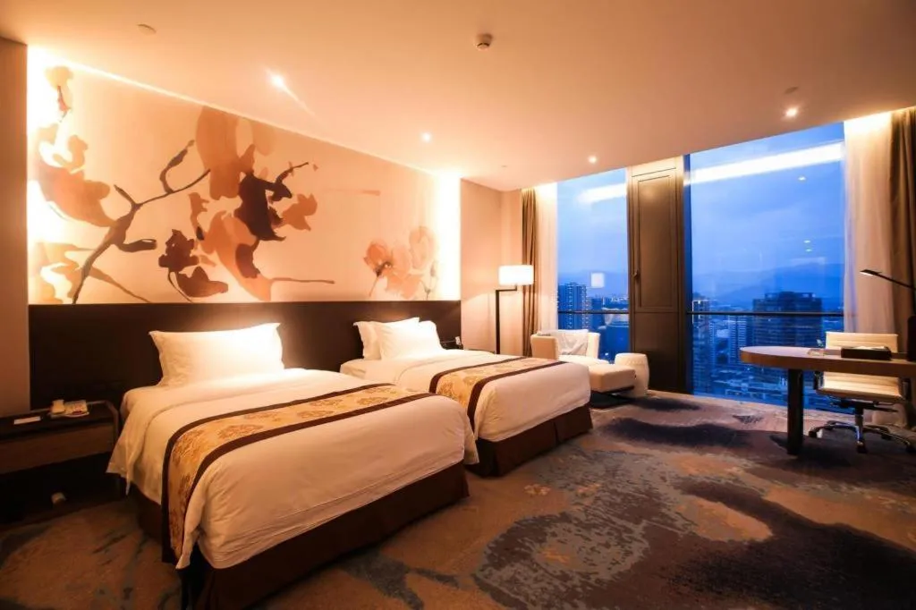 Bed in LONGYAN JINGHUA FLIPORT HOTEL