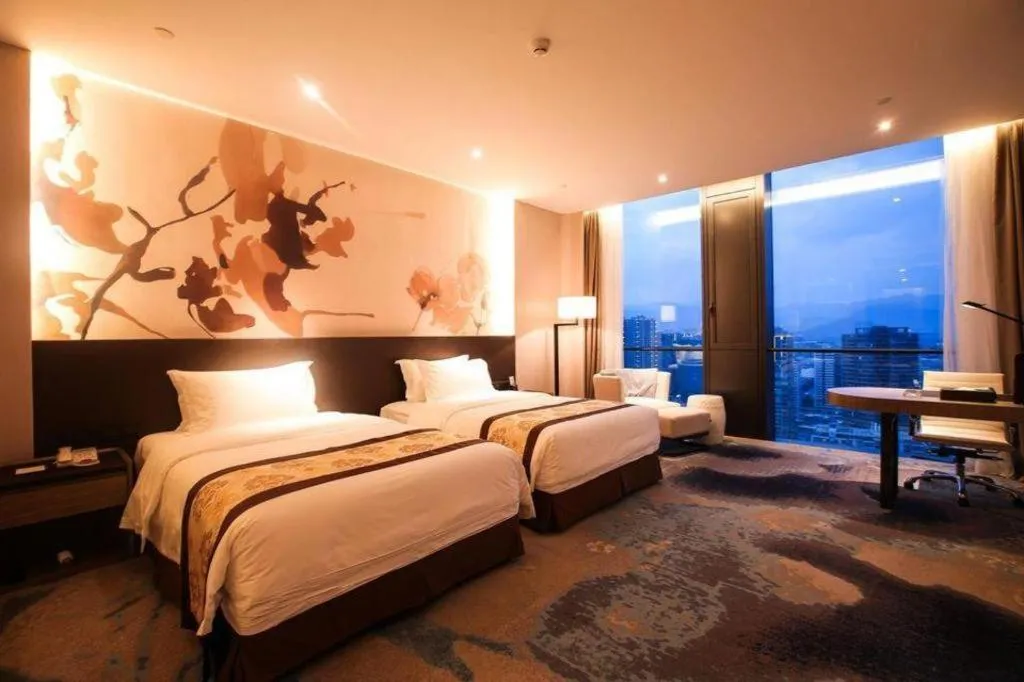 Bed in LONGYAN JINGHUA FLIPORT HOTEL