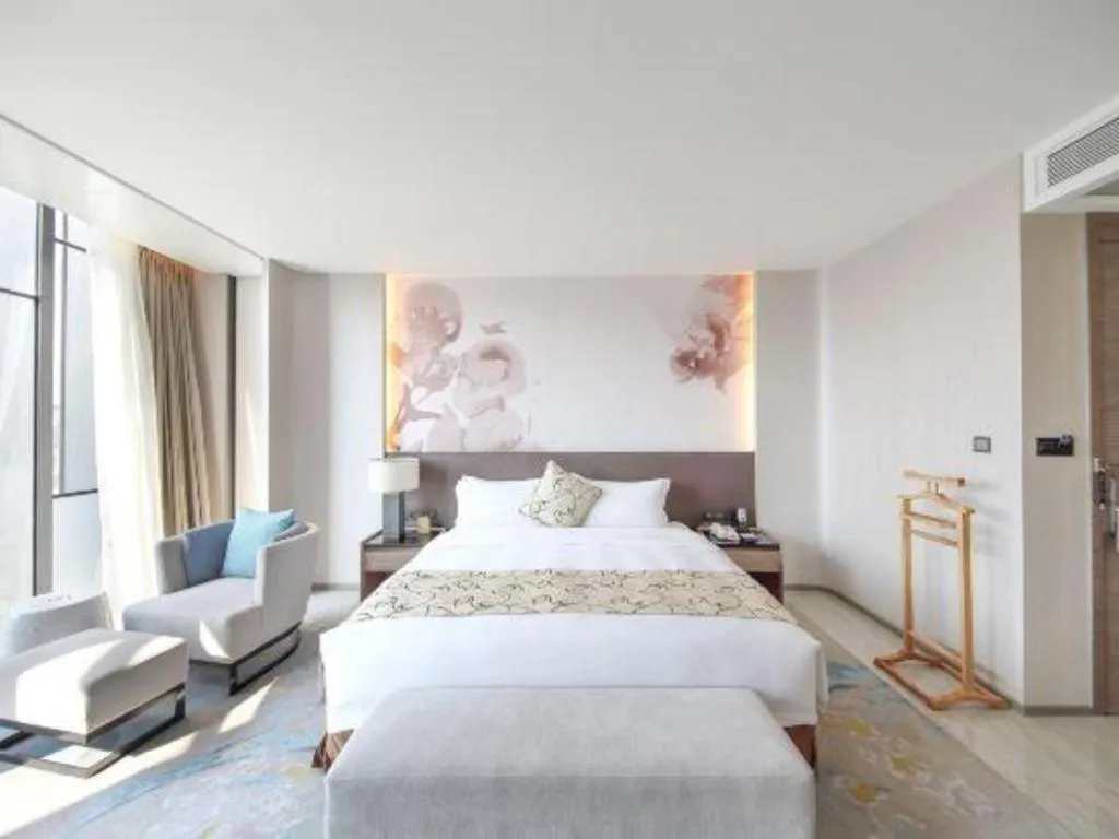 Bed in LONGYAN JINGHUA FLIPORT HOTEL