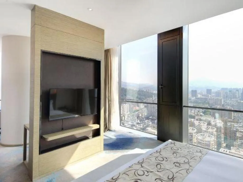 Bed in LONGYAN JINGHUA FLIPORT HOTEL