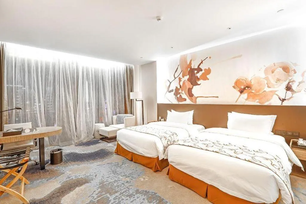 Bed in LONGYAN JINGHUA FLIPORT HOTEL