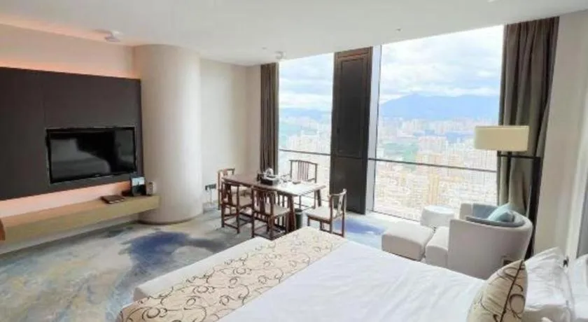 Bed in LONGYAN JINGHUA FLIPORT HOTEL